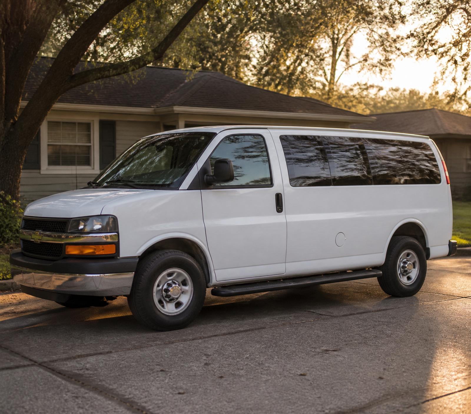 A clean white passenger van parked in a quiet East Harris County neighborhood at golden hour
